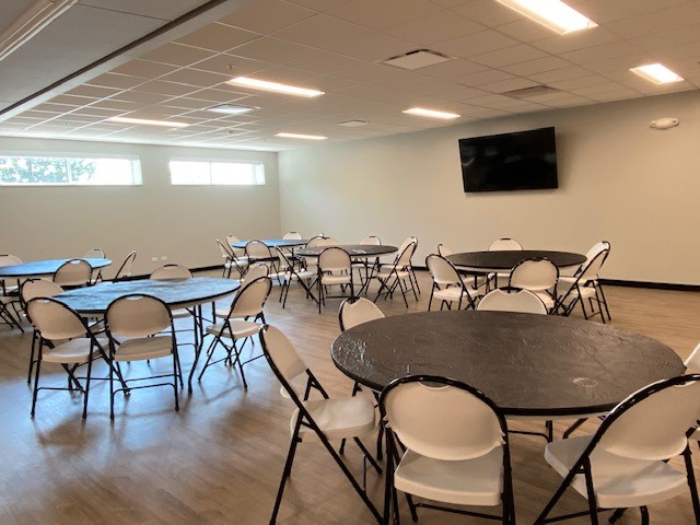 Large activity room with tables and chairs