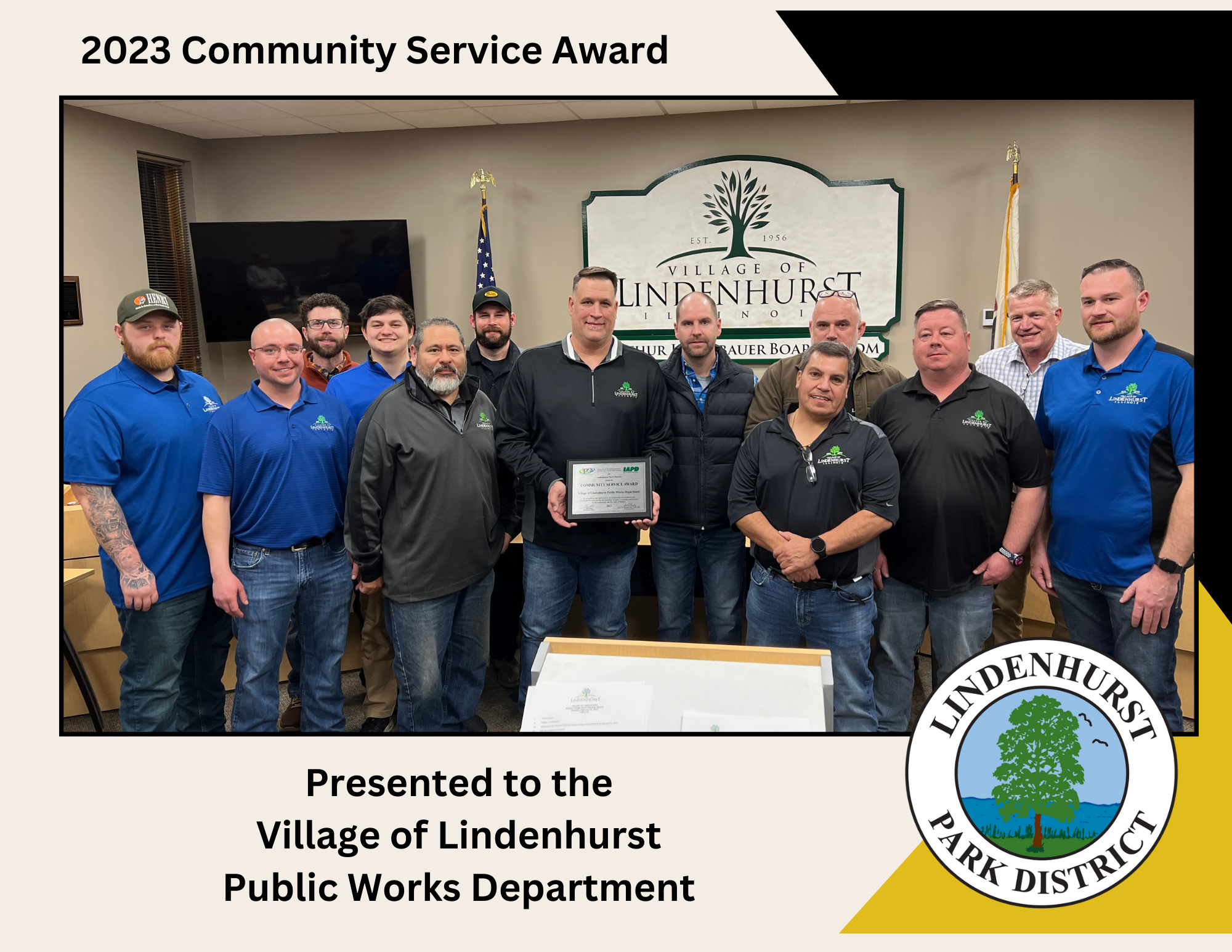The image shows a group of men from the Village of Lindenhurst Public Works Department receiving the 2023 Community Service Award. They are standing in a room with the Village of Lindenhurst seal in the background, holding a plaque that commemorates the award.