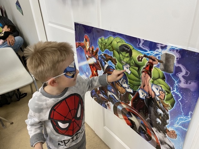 Young boy enjoying Superhero themed birthday party